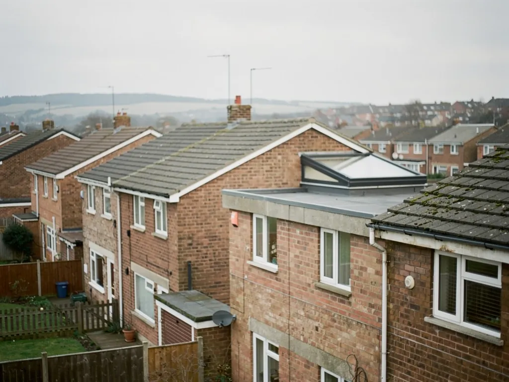 Modern brick houses with a flat rooflight on an extension, seen from above