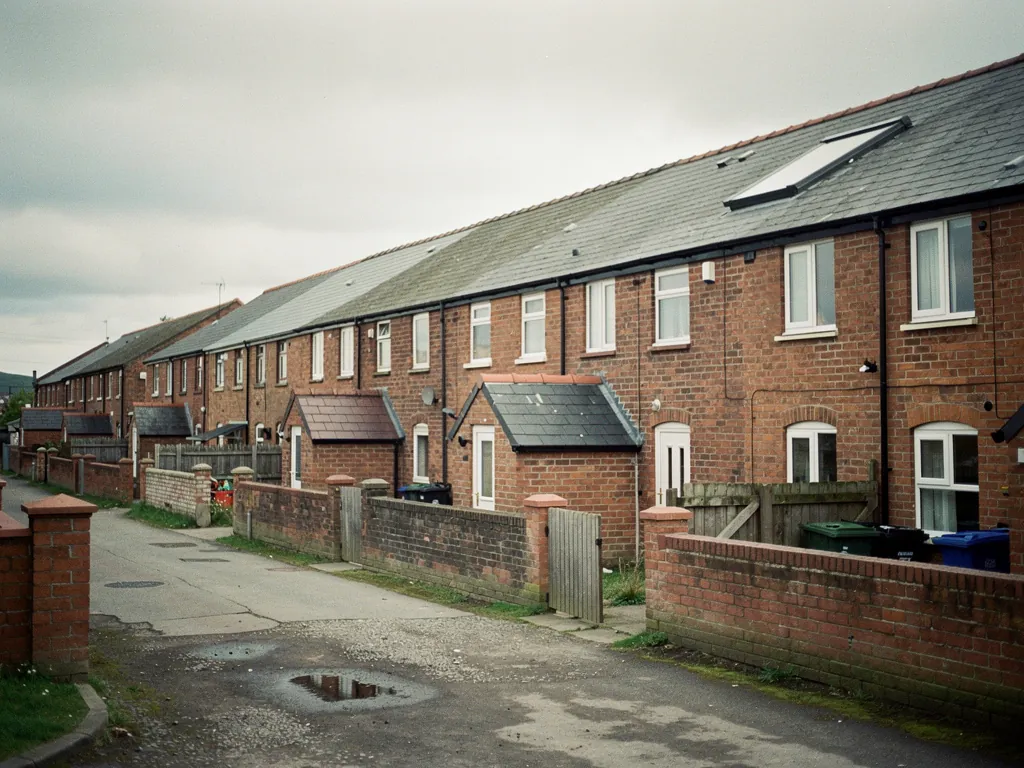 Long brick terrace row beside a back lane with yard walls