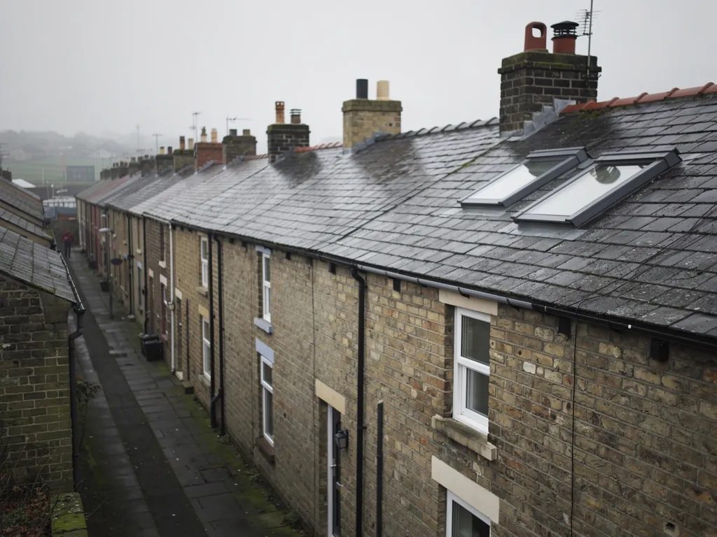 Stone terraced rooftops with roof windows on a misty day