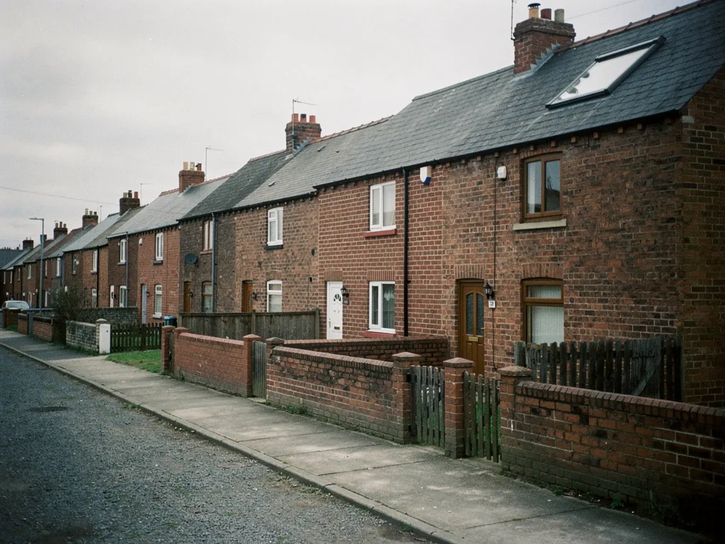 Brick terraced row with front walls along a quiet street