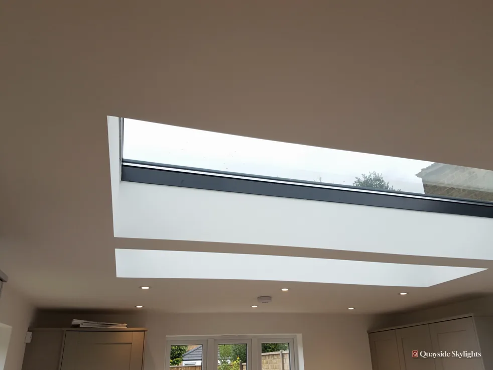 Looking up at a flat rooflight in a ceiling with a neighbouring roof beyond