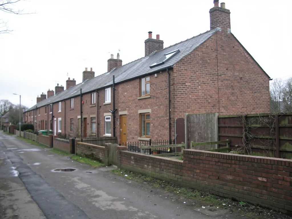 Brick terrace row with chimneys beside a narrow lane