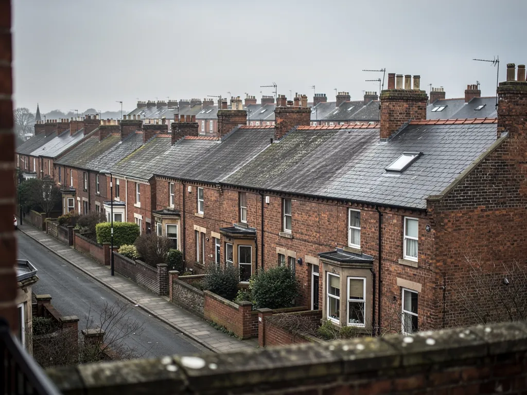 Brick terraces with bay windows and slate roofs seen from an upper window